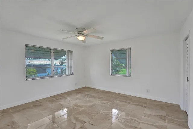 a view of livingroom with window ceiling fan and hardwood floor