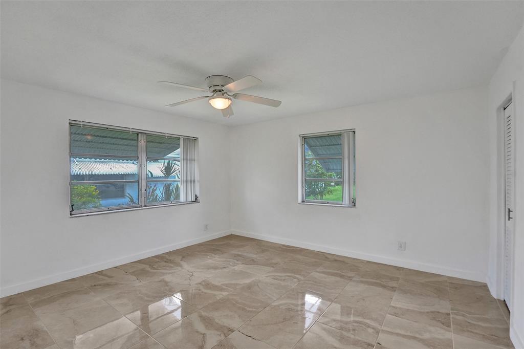 340 Northwest 25th Court Pompano Beach, FL 33064 - Photo 11 of 17 a view of livingroom with window ceiling fan and hardwood floor