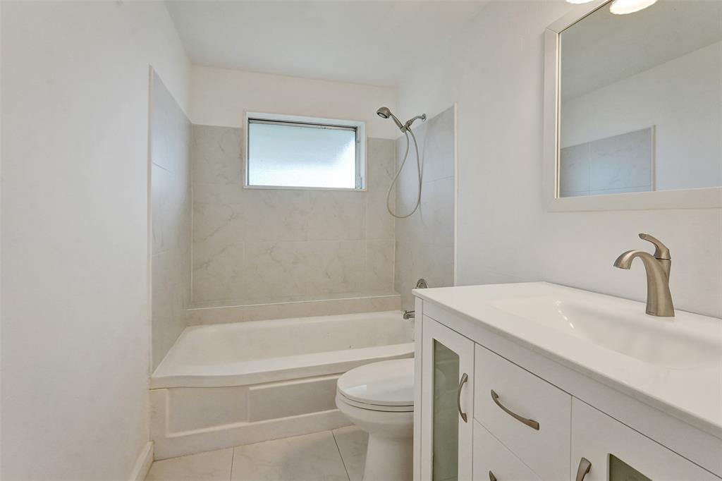 340 Northwest 25th Court Pompano Beach, FL 33064 - Photo 12 of 17 a bathroom with a sink a toilet and a bathtub