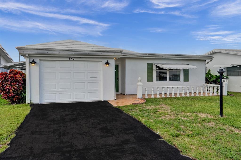 340 Northwest 25th Court Pompano Beach, FL 33064 - Photo 3 of 17 a view of a backyard with a garden