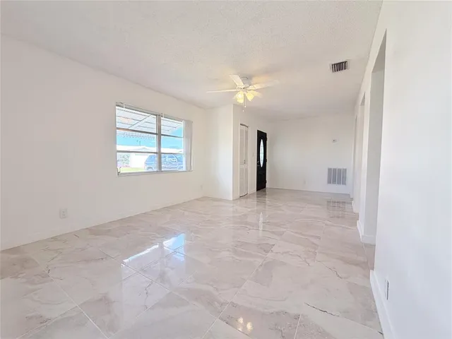 an empty room with windows and closet