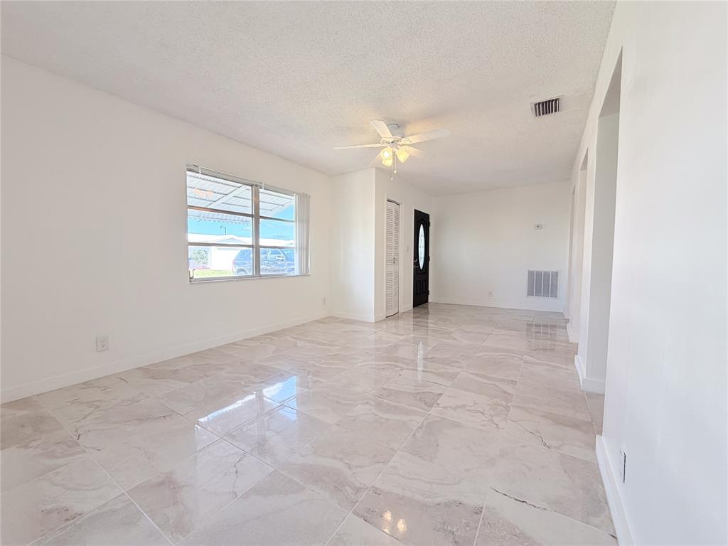 340 Northwest 25th Court Pompano Beach, FL 33064 - Photo 5 of 17 an empty room with windows and closet