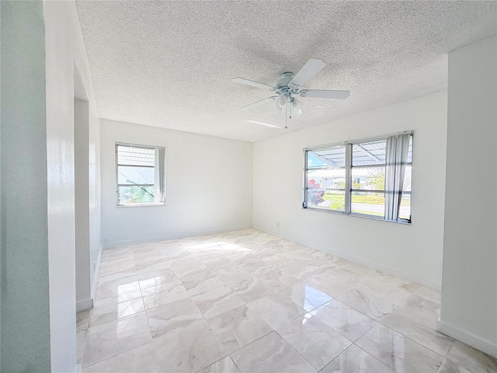 340 Northwest 25th Court Pompano Beach, FL 33064 - Photo 6 of 17 a view of an empty room with a window