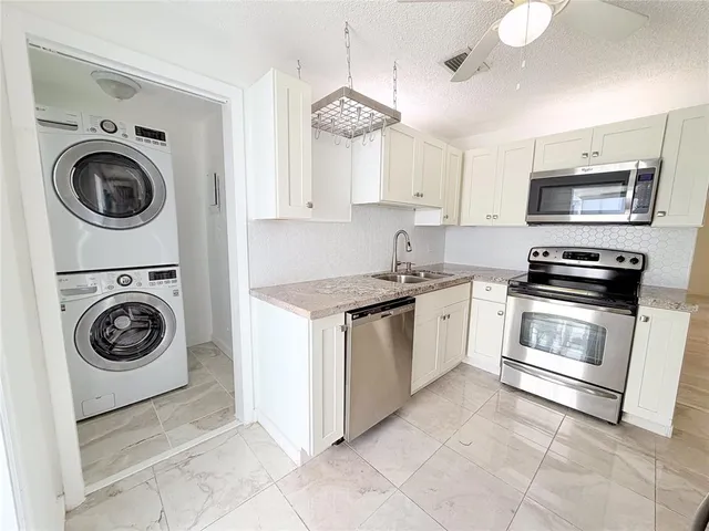 a kitchen with a stove top oven and cabinets