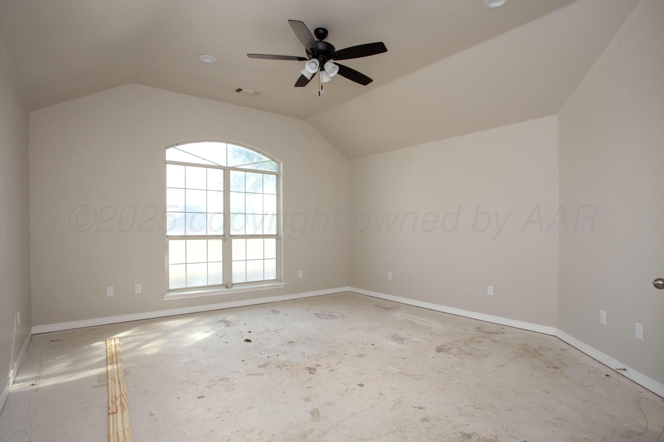 9050 Greyhawk Road Amarillo, TX 79119 - Photo 25 of 55 an empty room with a window and a fan