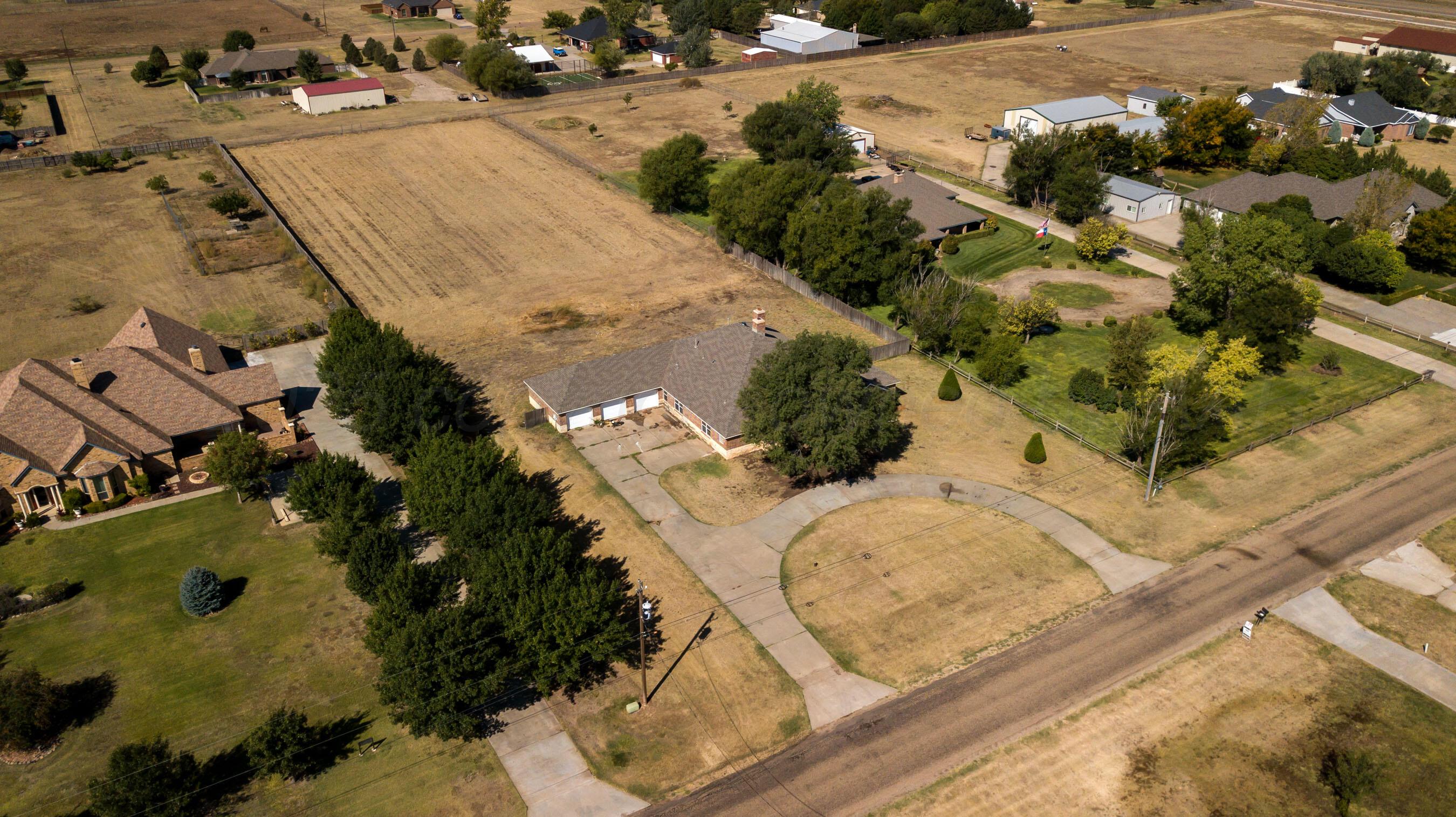 9050 Greyhawk Road Amarillo, TX 79119 - Photo 36 of 55 an aerial view of a house with a yard and lake view