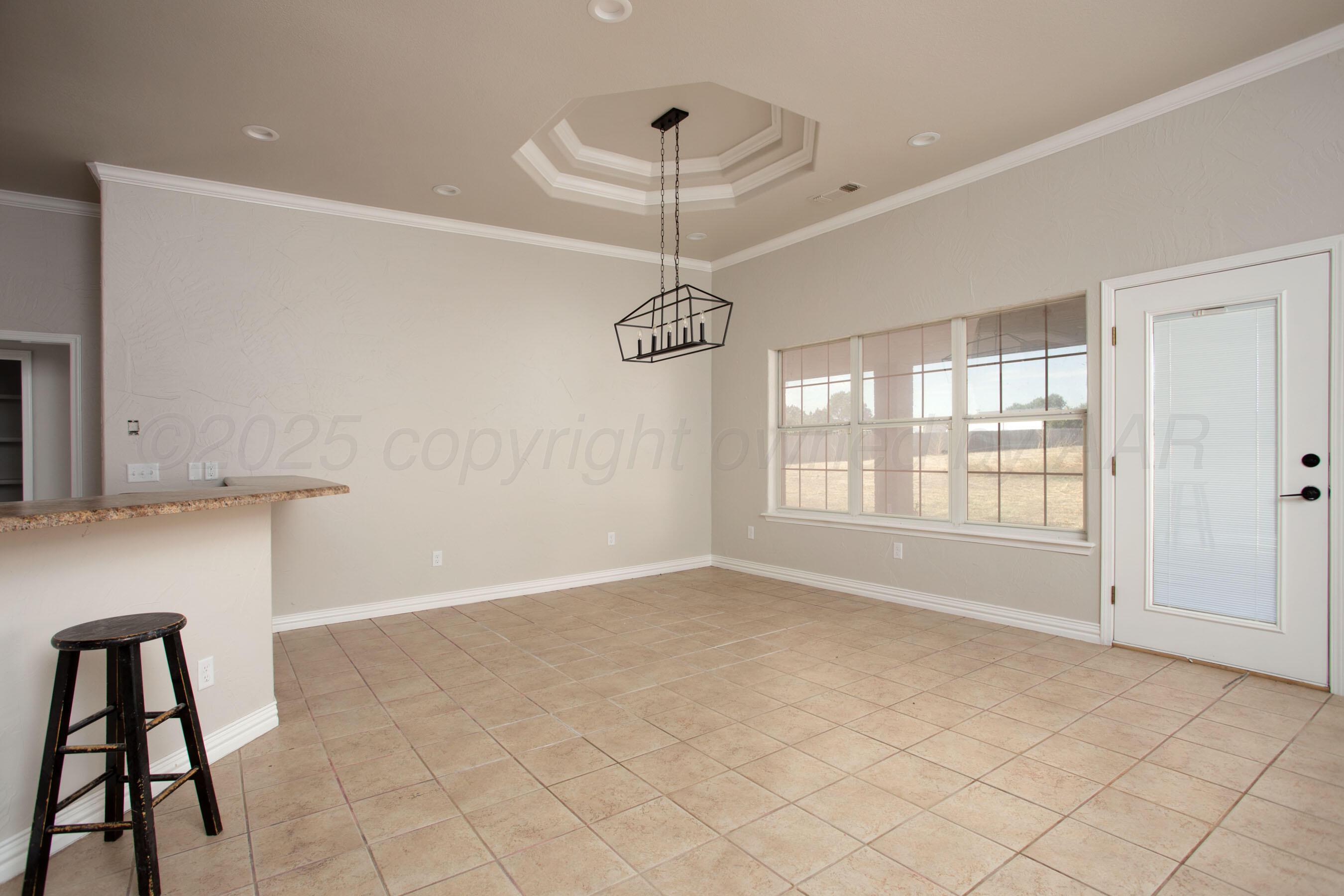 9050 Greyhawk Road Amarillo, TX 79119 - Photo 8 of 55 a view of an empty room with a window