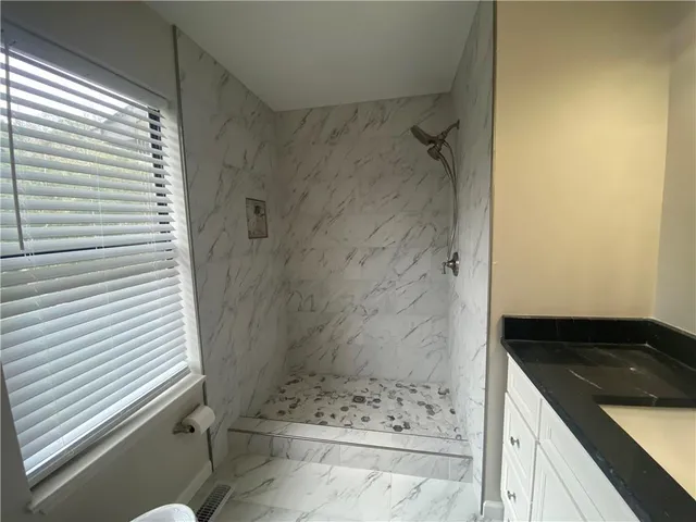 a bathroom with a bathtub and shower