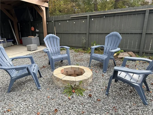a backyard of a house with table and chairs