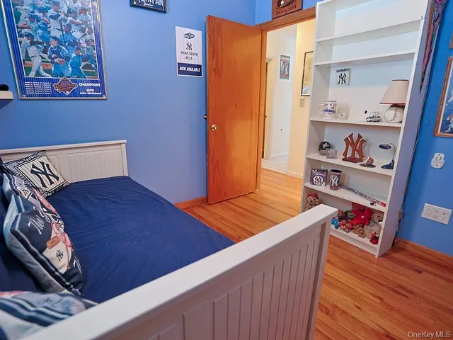 a view of a hallway with wooden floor and furniture