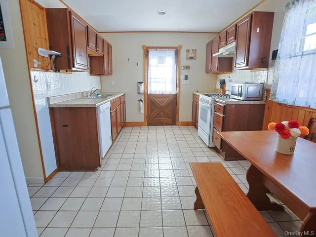 a kitchen with stainless steel appliances a sink stove and cabinets