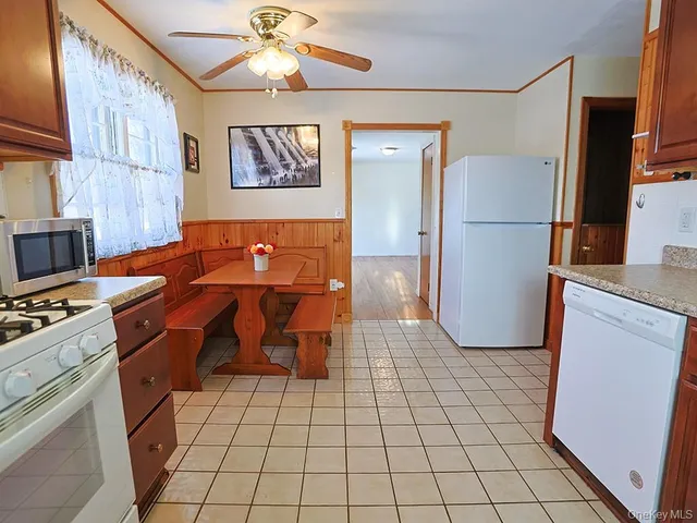a kitchen with granite countertop cabinets stainless steel appliances and a counter space