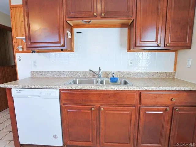 a kitchen with stainless steel appliances granite countertop a stove a refrigerator and a cabinets