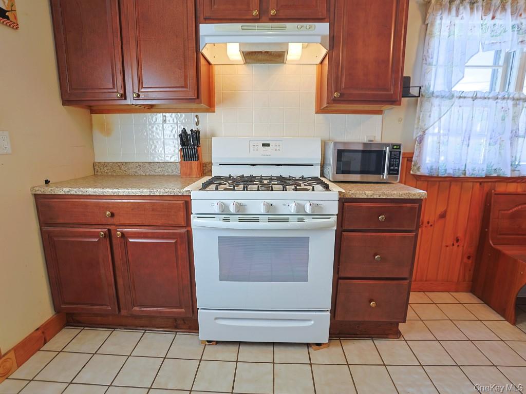 241 Freida Street Montgomery, NY 12549 - Photo 20 of 41 a kitchen with stainless steel appliances granite countertop a stove a refrigerator and a cabinets