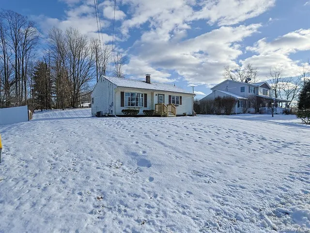 a view of a white house with a yard