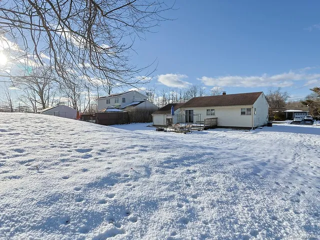 a front view of a house with cars parked