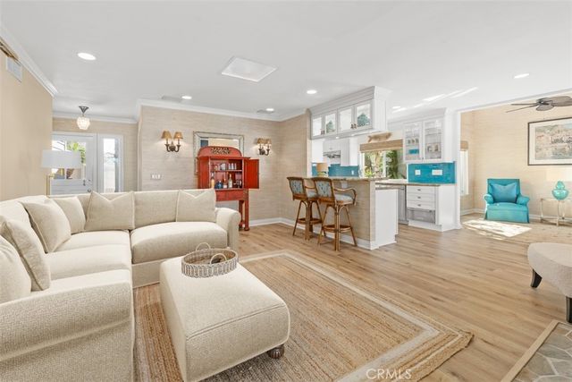 a living room with furniture and kitchen view
