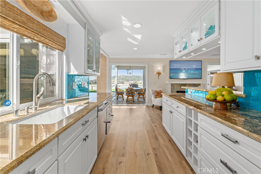 24115 Gourami Bay Dana Point, CA 92629 - Photo 9 of 39 a large kitchen with stainless steel appliances granite countertop a lot of counter space and a large window