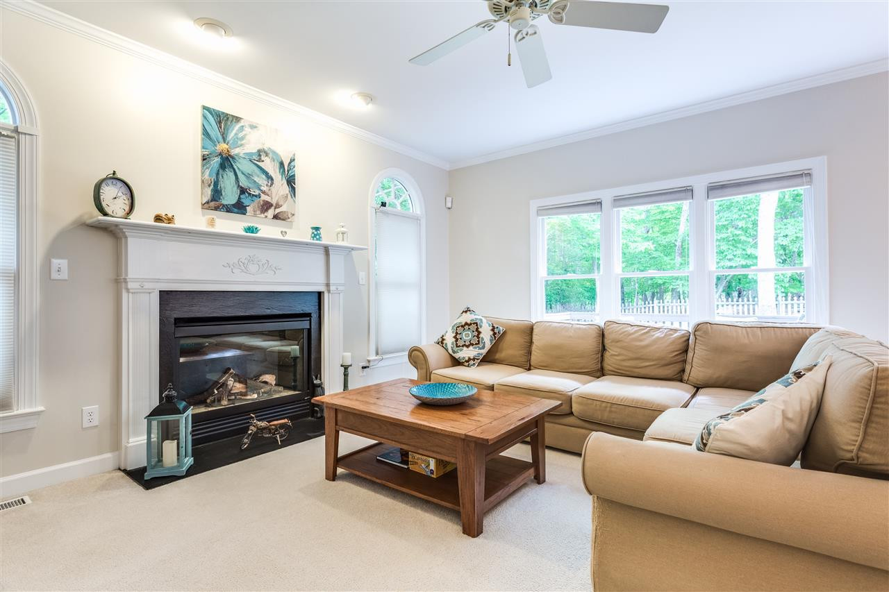 2737 Sunnystone Way Raleigh, NC 27613 - Photo 8 of 24 Gorgeous family room with gas fireplace and a wall of windows over looking the private, fenced in backyard. Family Room