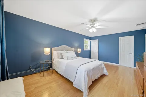a bedroom with a bed and a ceiling fan