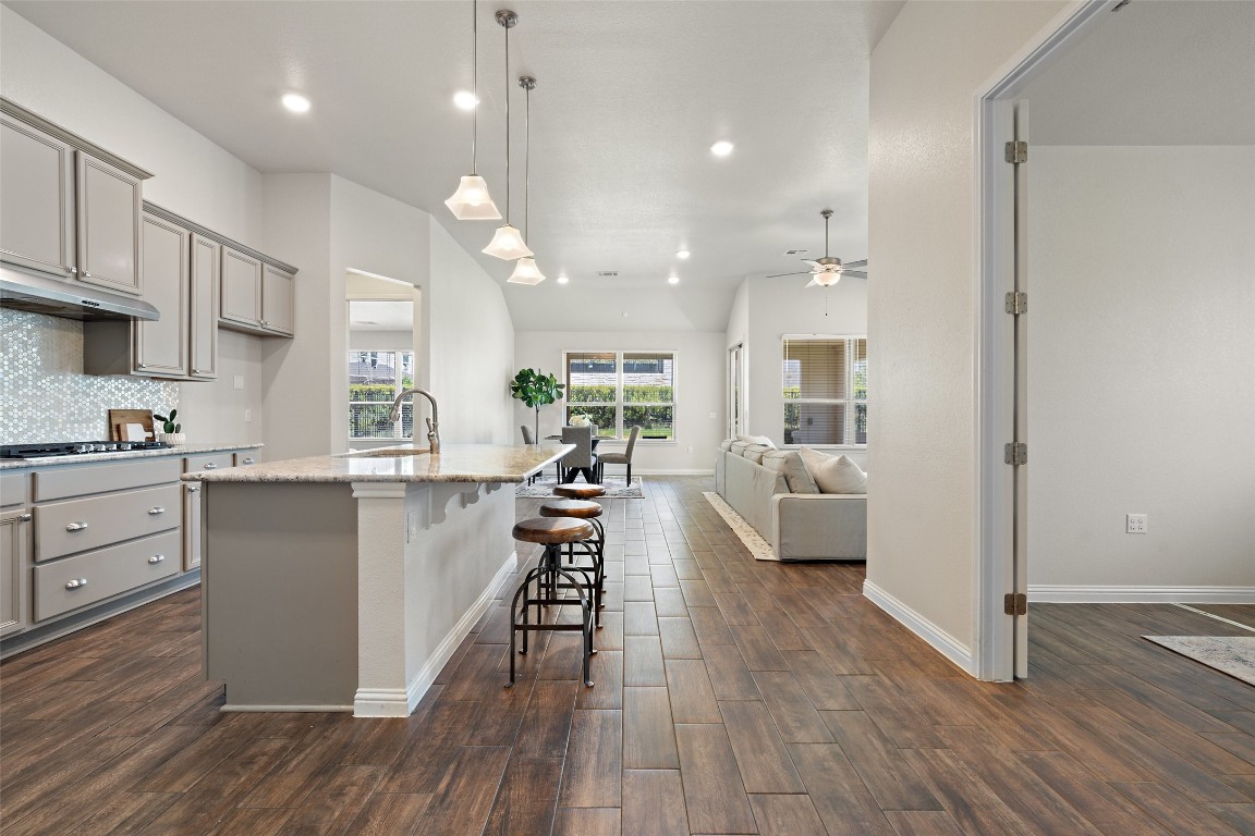 This open layout is accentuated with low-maintenance, wood-look tile throughout the living spaces tying it all together! Plus, upgrades like pot & pan drawers, under cabinet lighting, walk-in pantry and more!