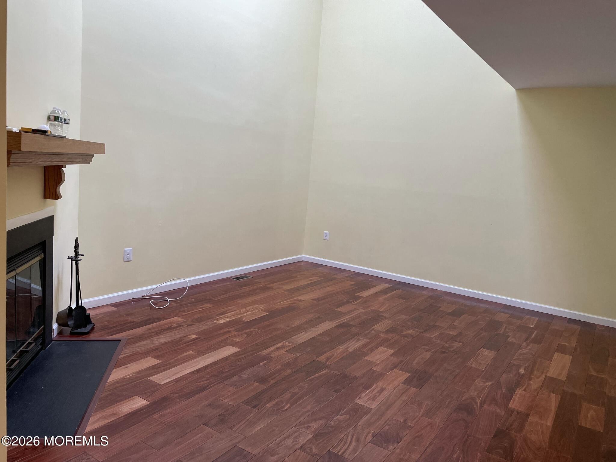 19 Clavendon Court Middletown, NJ 07748 - Photo 4 of 21 a view of a room with wooden floor and a fireplace