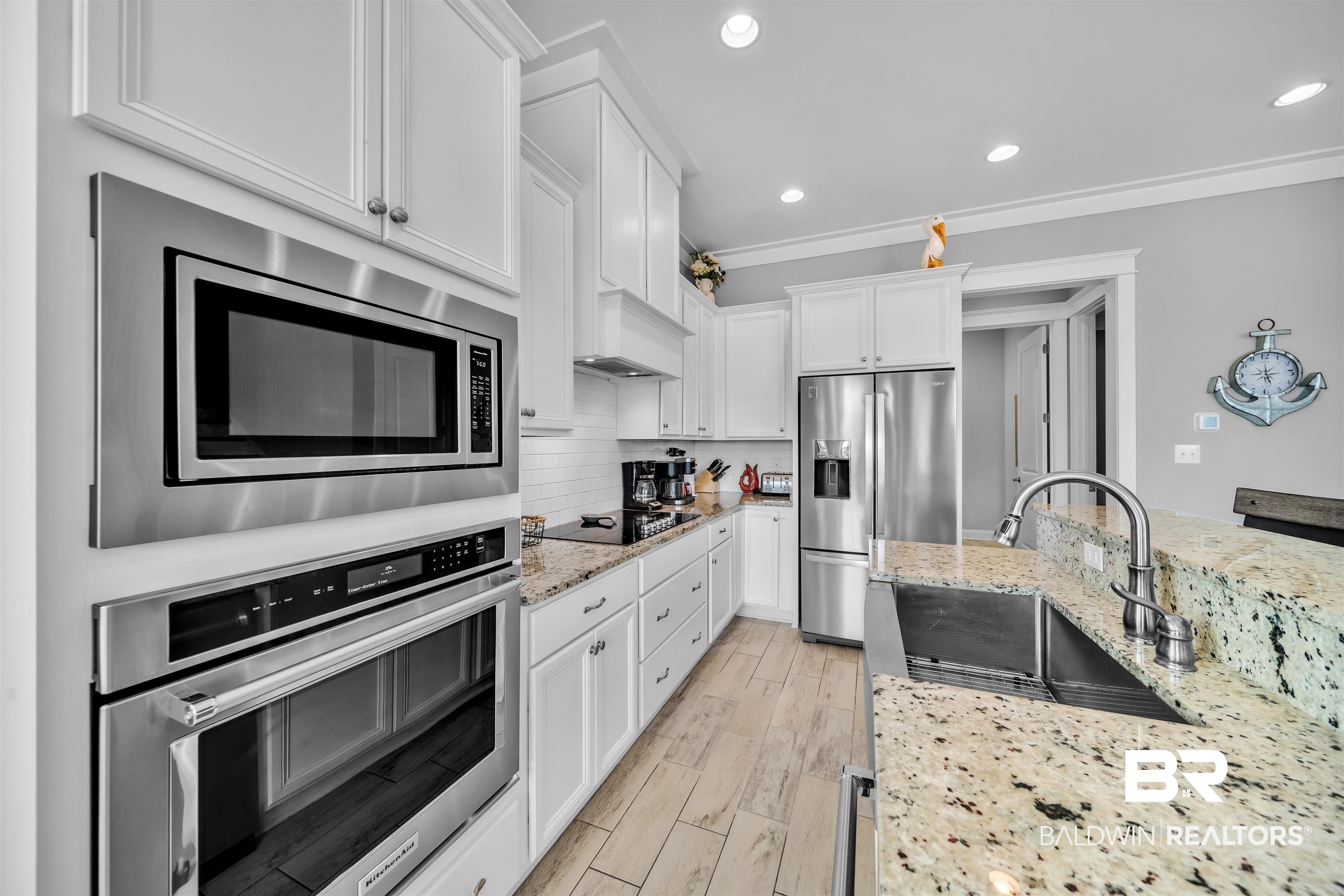 47 Parks Edge Orange Beach, AL 36561 - Photo 5 of 40 Kitchen featuring decorative backsplash, appliances with stainless steel finishes, recessed lighting, white cabinets, and crown molding