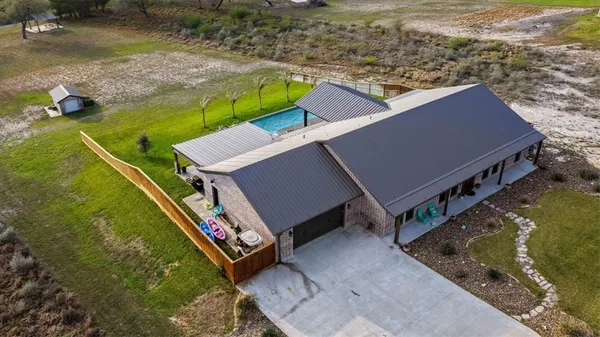 an aerial view of a house with a yard
