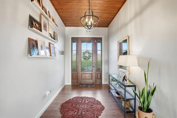 a living room with furniture a fireplace and a floor to ceiling window