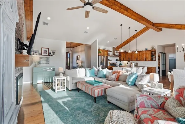 a view of a dining room with furniture large windows and wooden floor