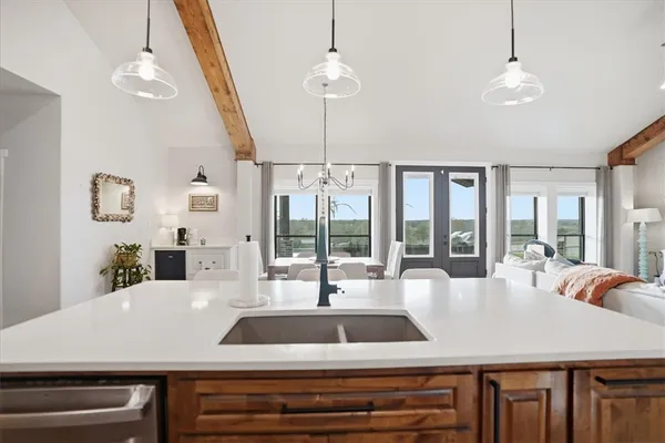 a kitchen with stainless steel appliances a cabinets and a window