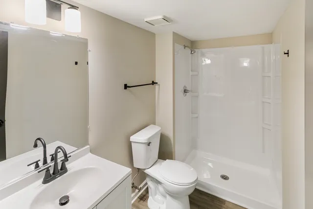 a bathroom with a sink toilet and shower