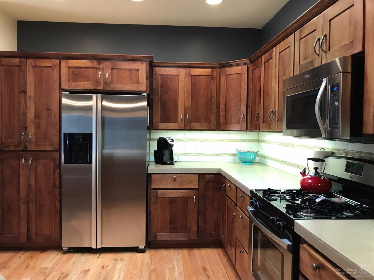2422 Northwest Awbrey Road Bend, OR 97703 - Photo 7 of 21 a kitchen with stainless steel appliances granite countertop a sink stove and refrigerator