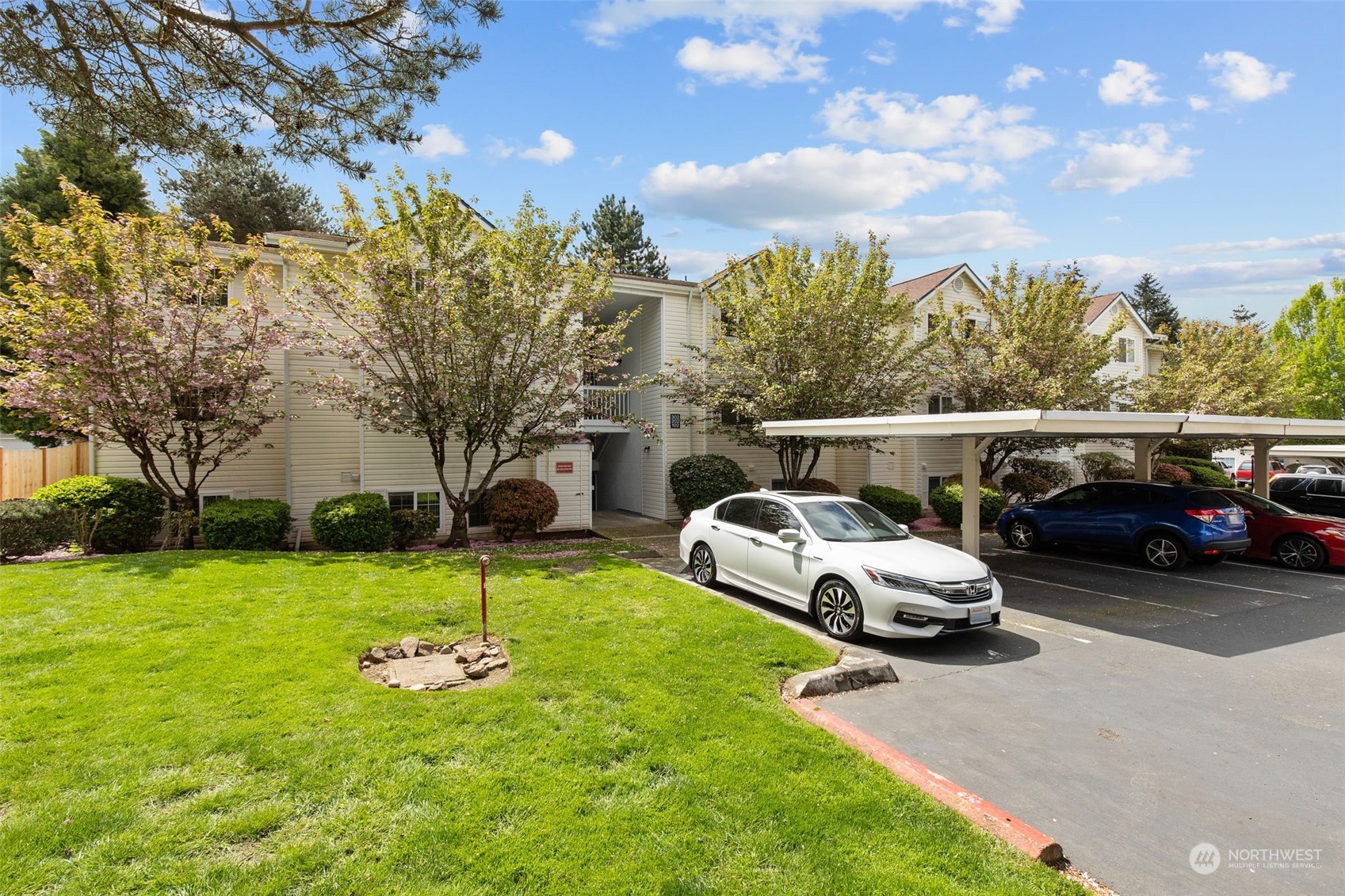 a view of a cars park in front of a house