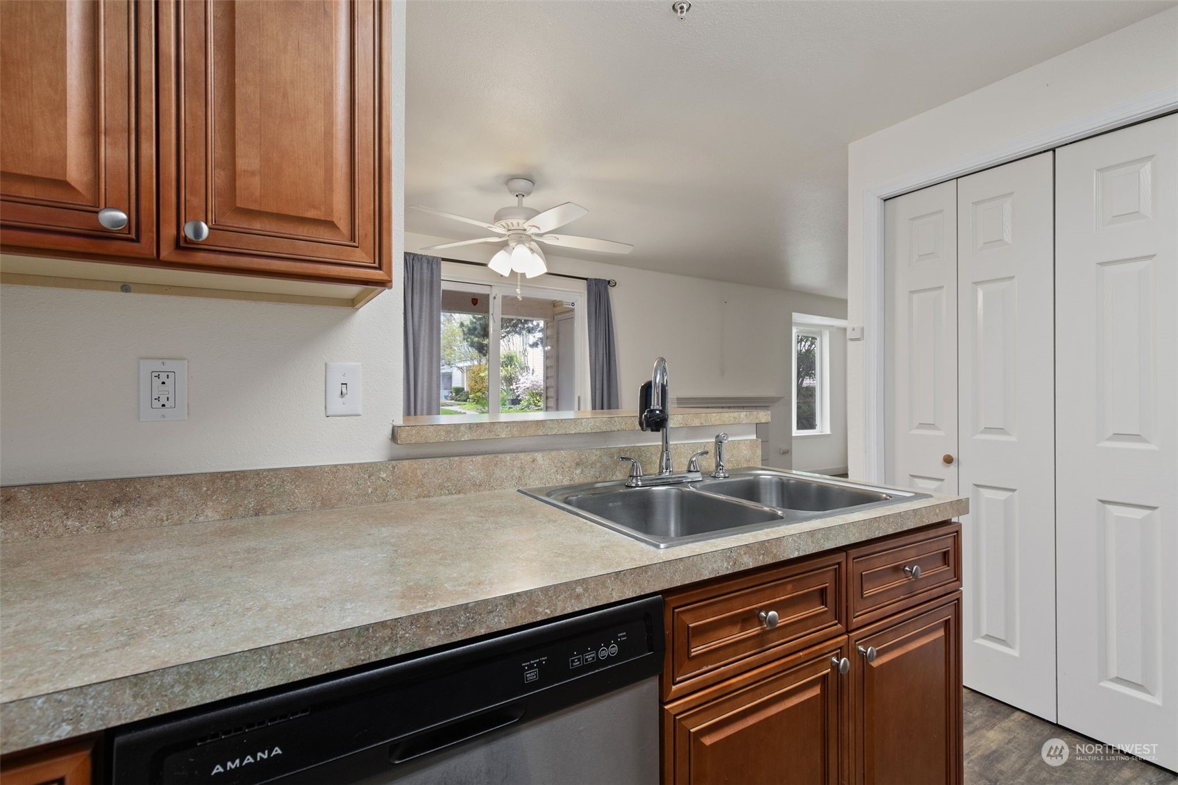 11002 Southeast Petrovitsky Road, Unit E101 Renton, WA 98055 - Photo 13 of 40 a kitchen with granite countertop a sink and cabinets