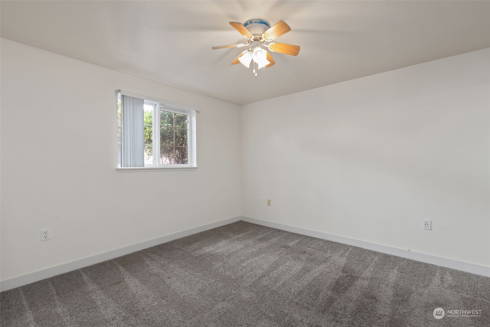 11002 Southeast Petrovitsky Road, Unit E101 Renton, WA 98055 - Photo 15 of 40 an empty room with a window and a fan