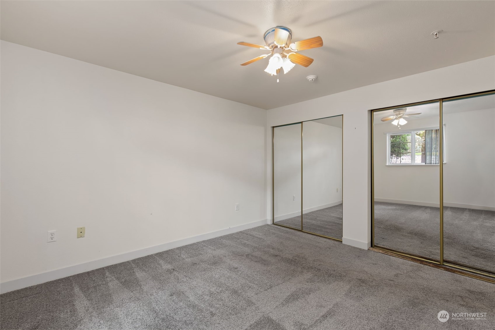 11002 Southeast Petrovitsky Road, Unit E101 Renton, WA 98055 - Photo 16 of 40 an empty room with closet and a chandelier fan