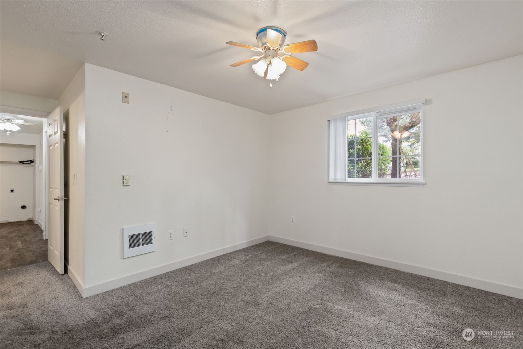 11002 Southeast Petrovitsky Road, Unit E101 Renton, WA 98055 - Photo 18 of 40 an empty room with a window and a ceiling fan