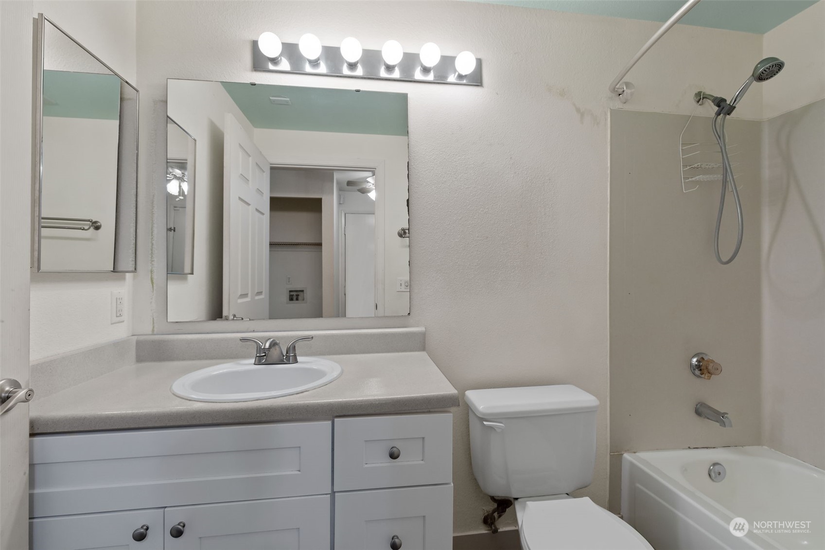 11002 Southeast Petrovitsky Road, Unit E101 Renton, WA 98055 - Photo 24 of 40 a bathroom with a sink a toilet and shower