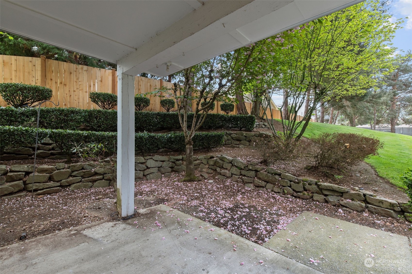 11002 Southeast Petrovitsky Road, Unit E101 Renton, WA 98055 - Photo 26 of 40 a backyard of a house with plants and outdoor seating