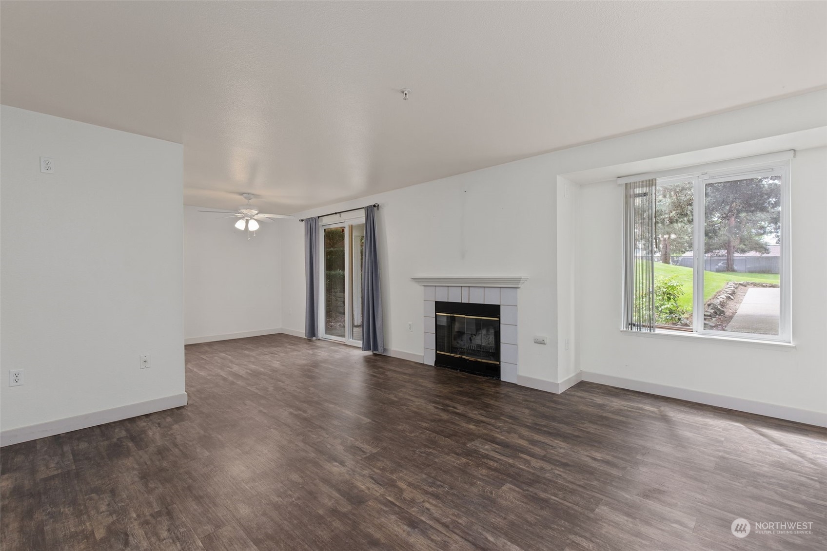 11002 Southeast Petrovitsky Road, Unit E101 Renton, WA 98055 - Photo 3 of 40 an empty room with windows and fireplace