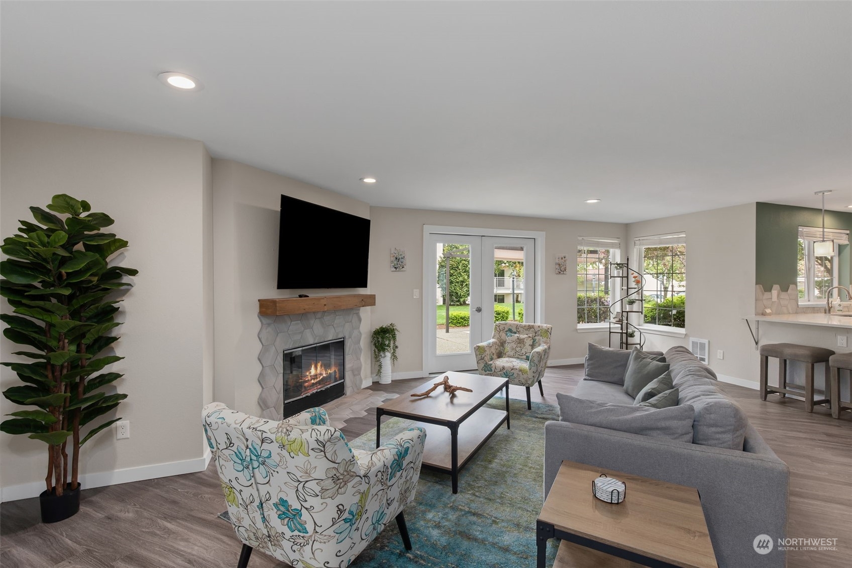 11002 Southeast Petrovitsky Road, Unit E101 Renton, WA 98055 - Photo 32 of 40 a living room with furniture a fireplace and a potted plant