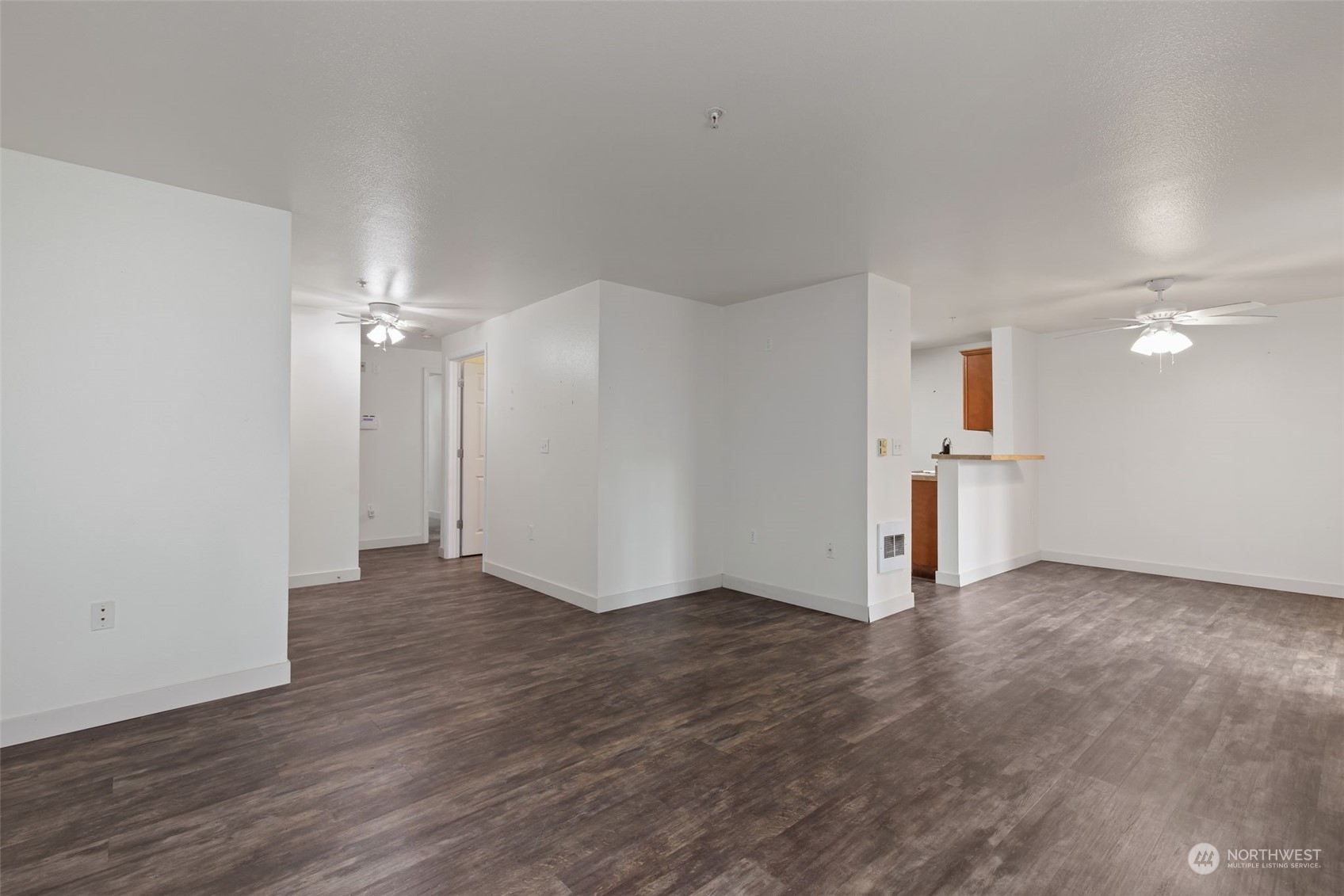 11002 Southeast Petrovitsky Road, Unit E101 Renton, WA 98055 - Photo 4 of 40 an empty room with wooden floor and windows
