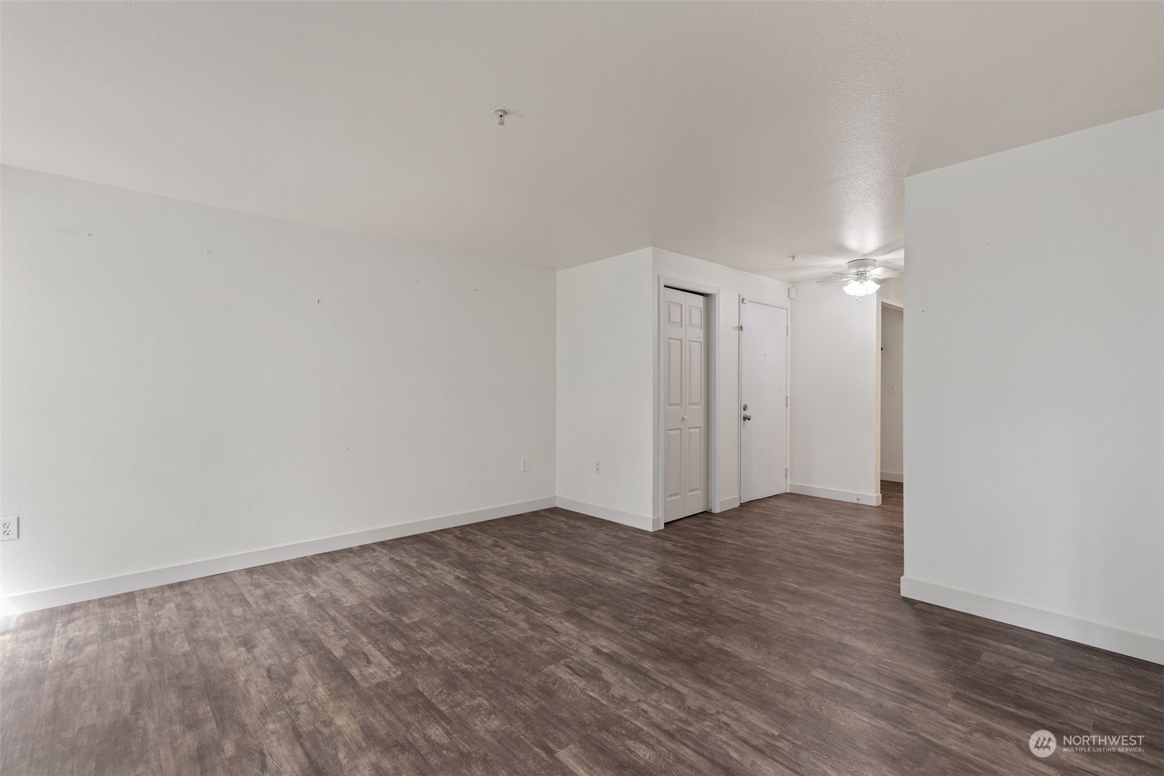 11002 Southeast Petrovitsky Road, Unit E101 Renton, WA 98055 - Photo 5 of 40 a view of an empty room with wooden floor