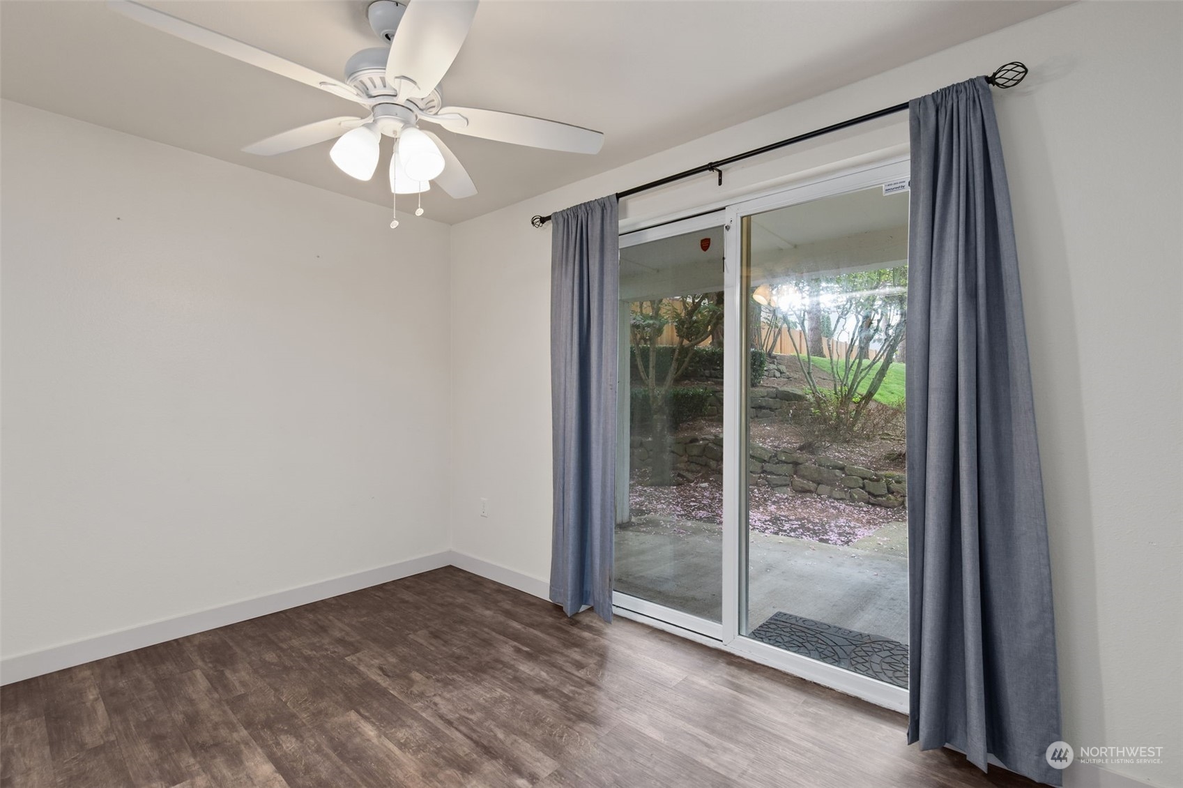 11002 Southeast Petrovitsky Road, Unit E101 Renton, WA 98055 - Photo 7 of 40 a view of an empty room with glass door