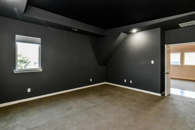 a view of empty room with window and ceiling fan