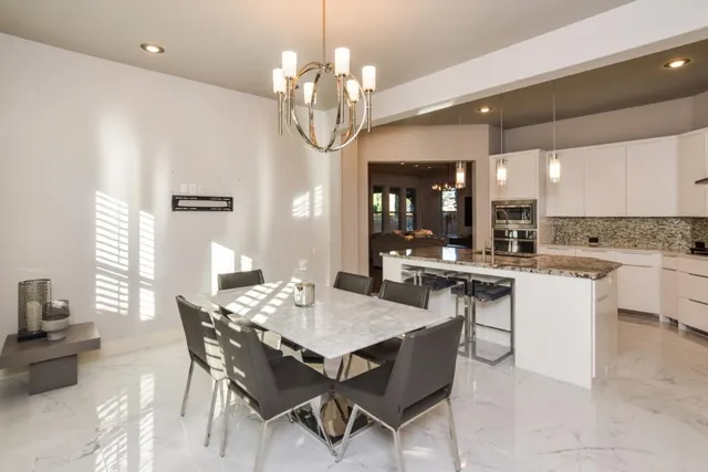 a living room with a table and chairs