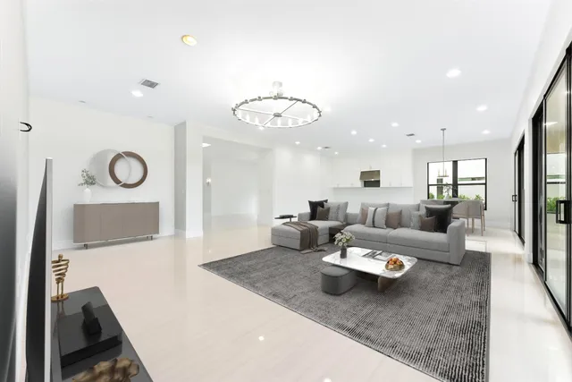 a large white kitchen with kitchen island a sink a center island stainless steel appliances and a cabinets