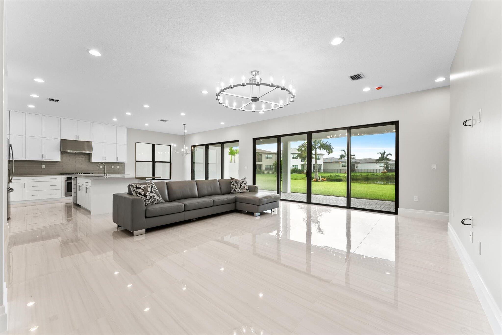 20107 Pacific Dunes Drive Boca Raton, FL 33434 - Photo 14 of 85 a living room with furniture and a floor to ceiling window