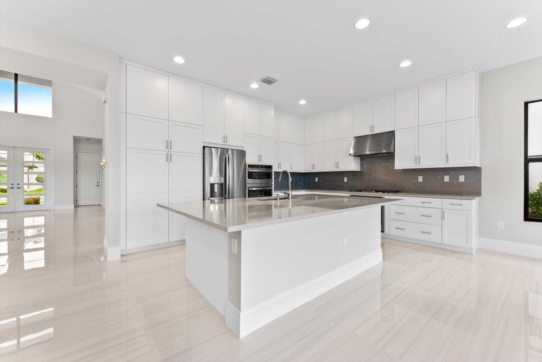 20107 Pacific Dunes Drive Boca Raton, FL 33434 - Photo 17 of 85 a large kitchen with stainless steel appliances lots of counter top space and cabinets